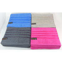 Assorted colours of premium bath towels stacked neatly.